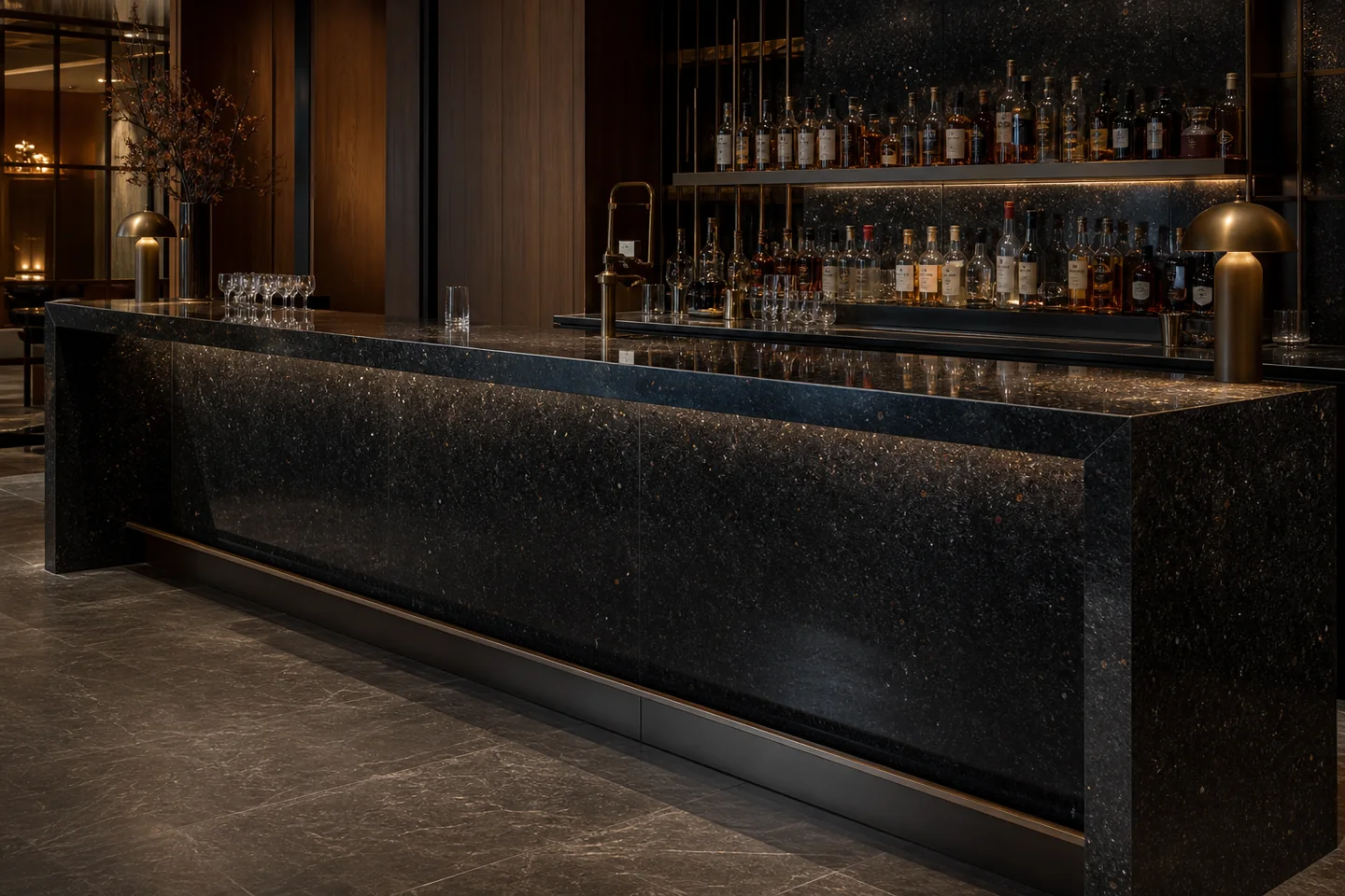 Deep-black granite with fine bronze mineral flecks applied to a luxury hospitality bar.
